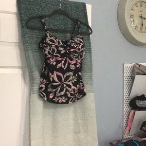 Pink and white design on black tank top.